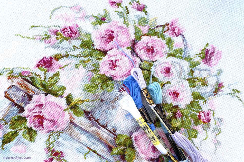 My cross-stitching journey initial project: roses in an old water can on a wooden stool